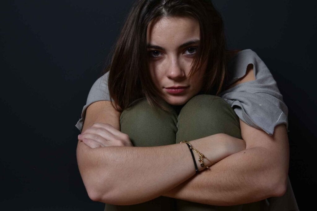 Woman experiencing distress associated with heroin withdrawal symptoms