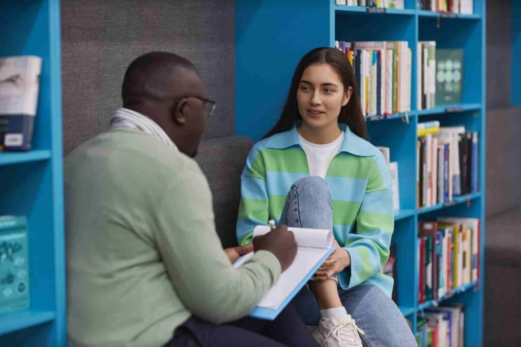 Teen speaking with a therapist during a Dialectical Behavior Therapy (DBT) session to build emotional regulation skills.