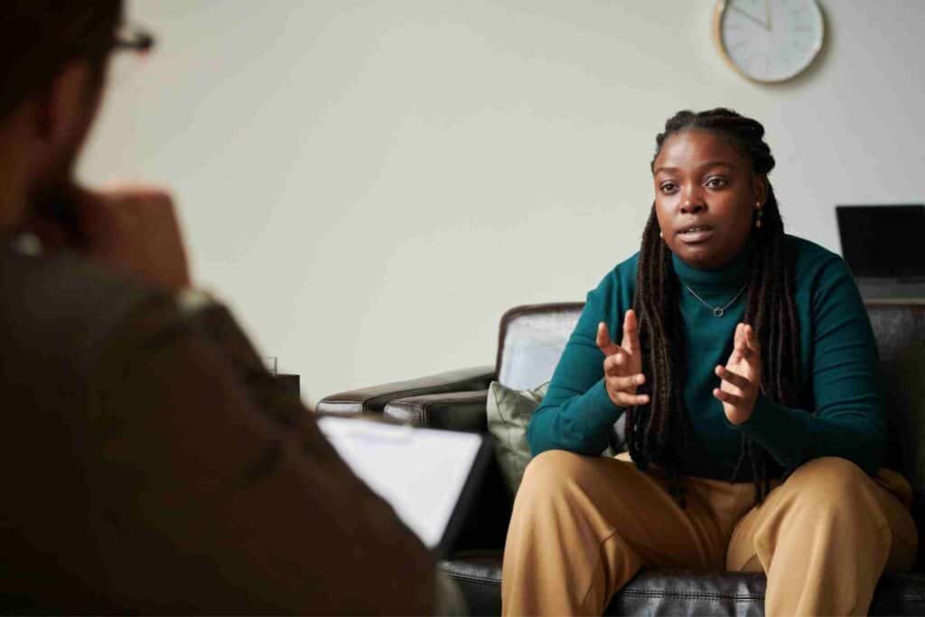 A woman speaks with a therapist during an individual counseling session for addiction recovery.