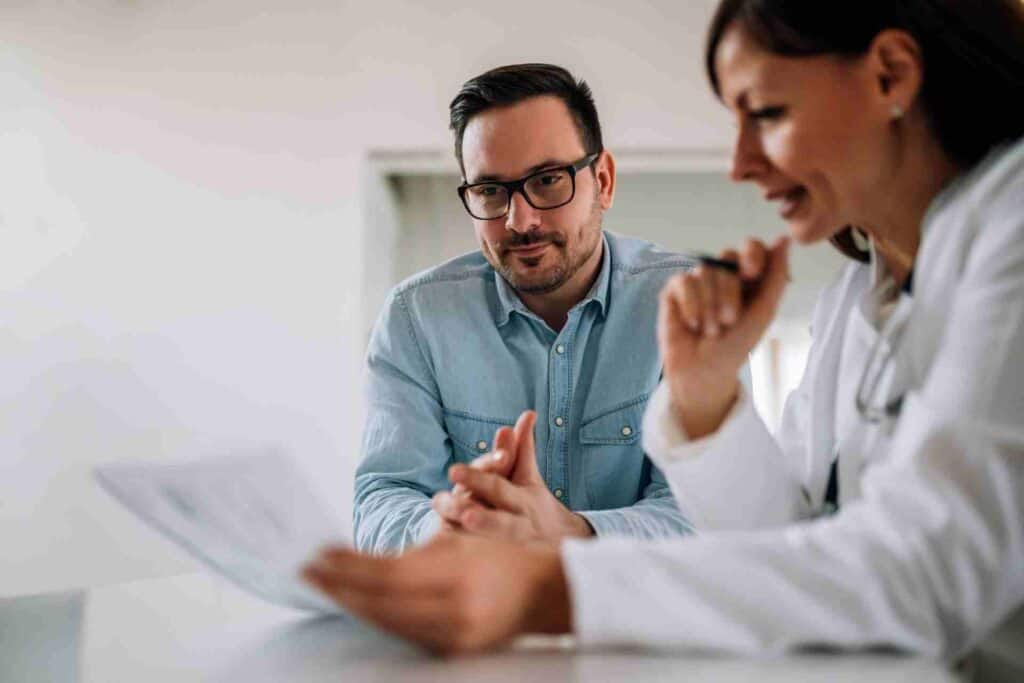 Does Insurance Cover Detox? 1 A healthcare professional reviewing insurance documents with a client during an addiction treatment consultation.
