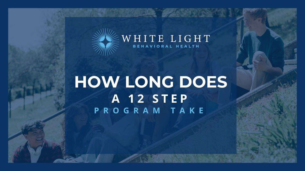 a group of people hanging out on stairs discussing the 12-step program