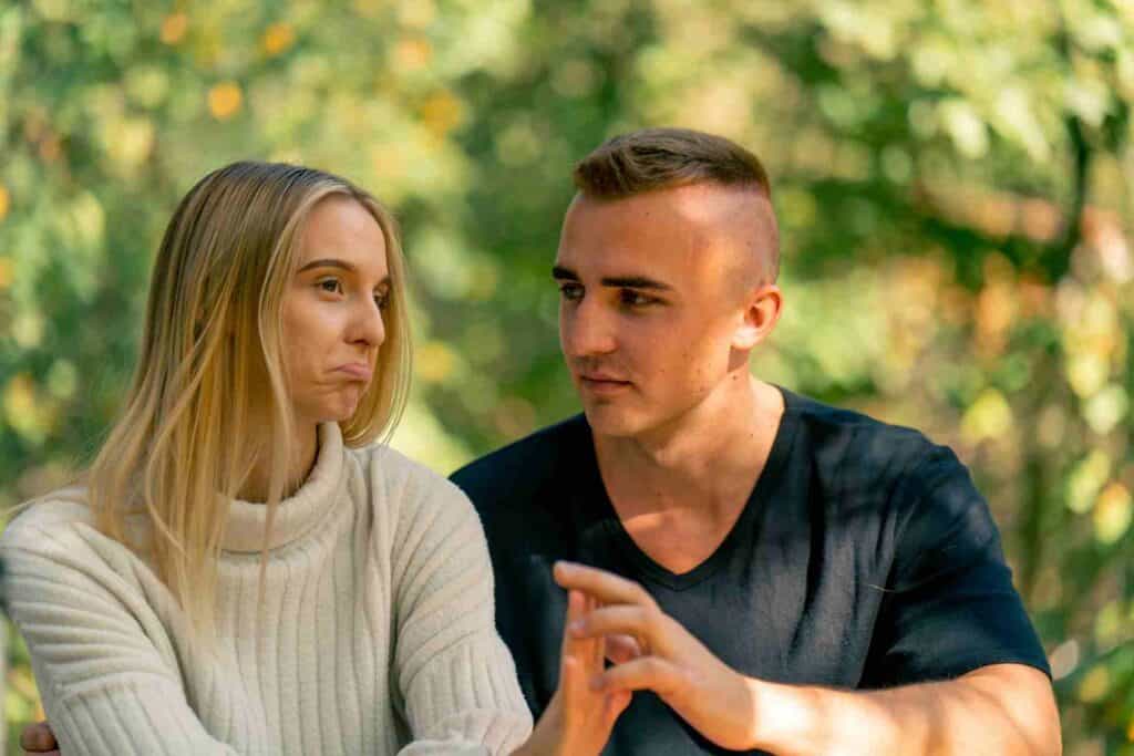Can You Force Someone Into Rehab? 1 A concerned woman declines a loved one's encouragement to seek addiction treatment during an emotional conversation outdoors.