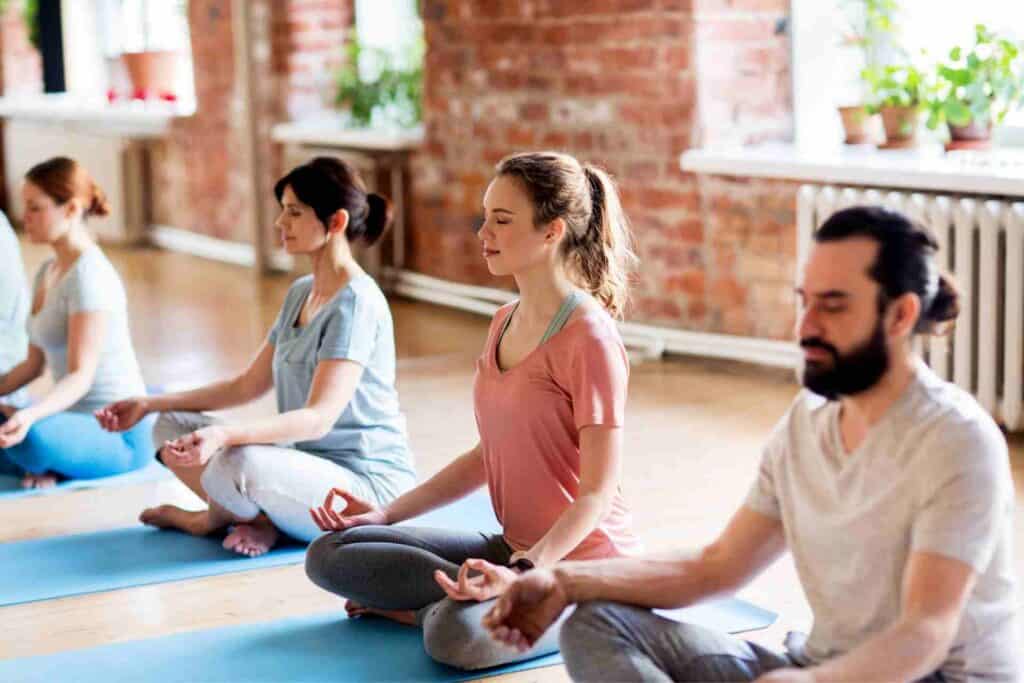 Yoga &Amp; Meditation Therapy 1 Adults practicing mindfulness meditation during a group wellness session to support recovery from major depressive disorder