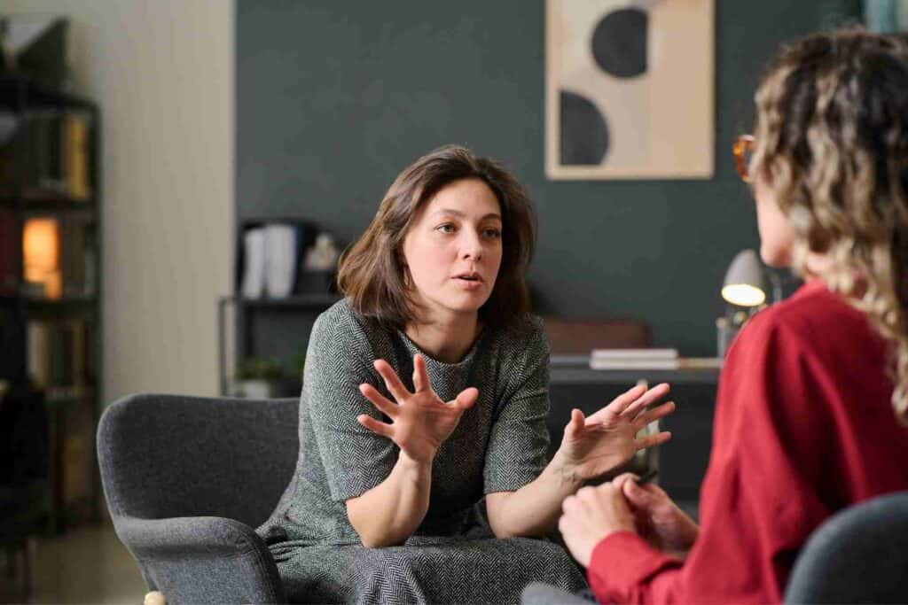 Inpatient Rehab Vs Outpatient Rehab: Which Is Right For You? 1 A woman speaks openly with a therapist during a one-on-one mental health counseling session.