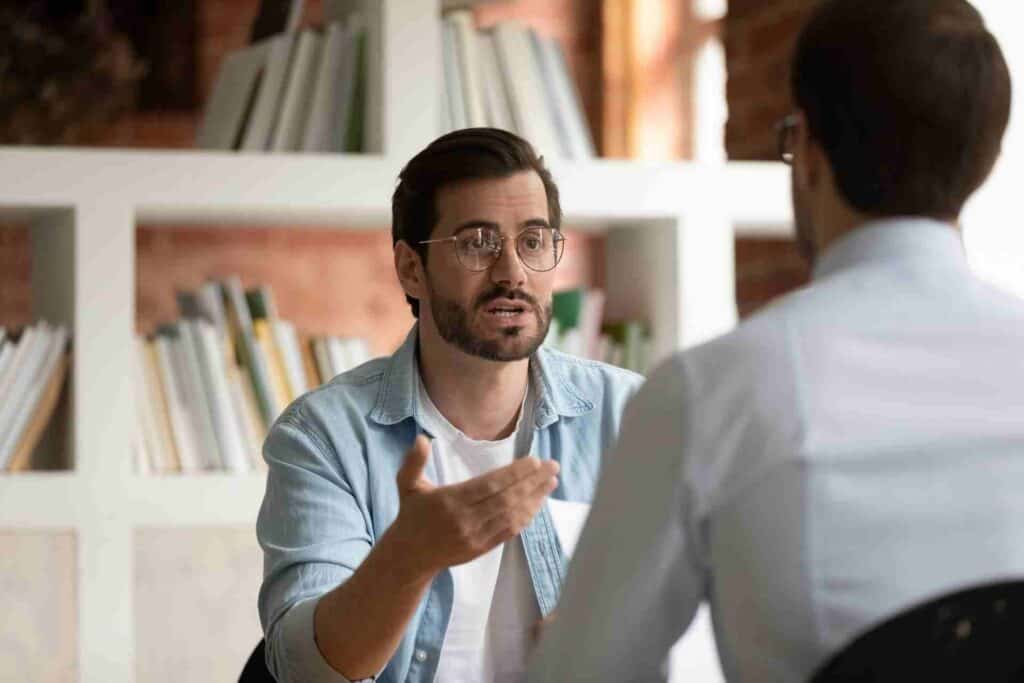 Man discussing rehab payment options with an addiction treatment admissions specialist